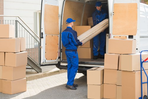 Student removals team handling boxes in a Chiswick residential street