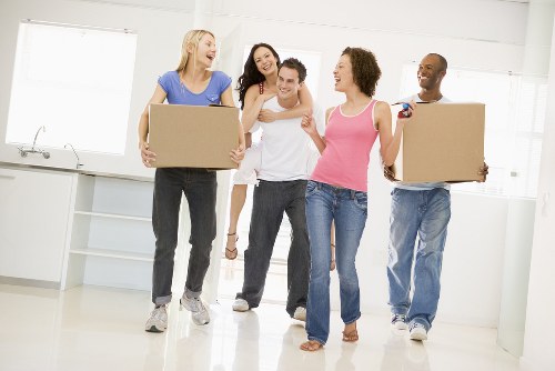 Removal team preparing furniture safely with protective wrapping