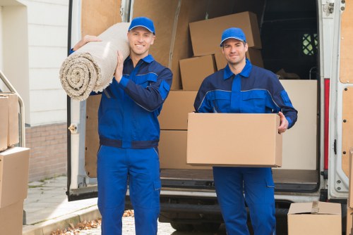 Trained removal staff carrying items carefully through a property