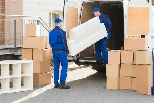 Removal team handling furniture during a flat move in Chiswick