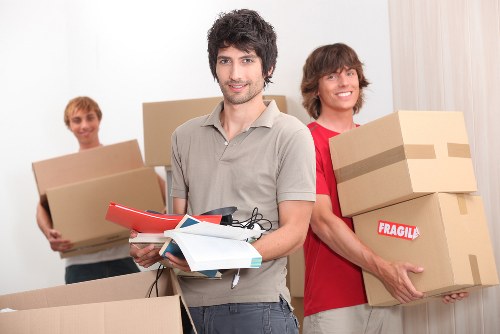 Specialist movers navigating a piano through a Chiswick property