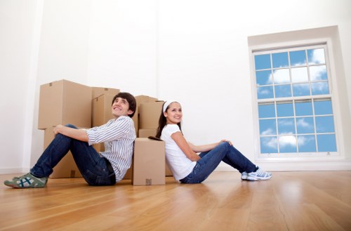 Removal team handling furniture in a Chiswick residential street