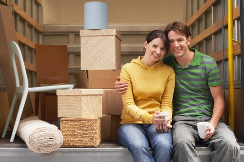 Packed moving boxes and furniture ready for transport in Chiswick