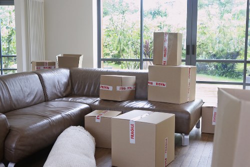 Movers organizing and wrapping household items for packing services in Chiswick